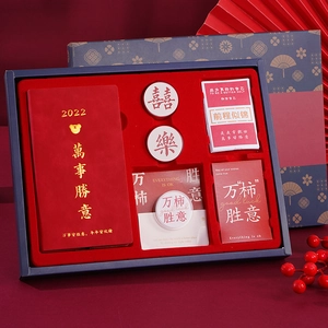 Detailed gift set view including red notebook, greeting cards, and artistic badges
