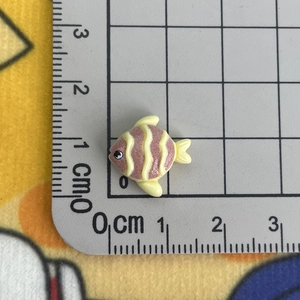 Close-up of pink and yellow striped resin fish charm measuring 1.5 cm for crafts