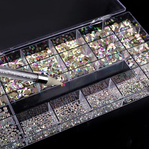 Detailed view of the nail art rhinestones kit with wax pen picking up a square crystal