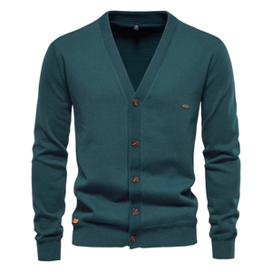 Close-up of dark green knitted cardigan for men featuring premium texture and size S label