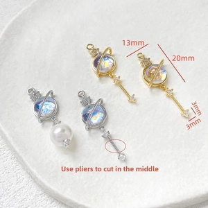 Detailed size view of 14k gold-plated planet pendants with zircon and cat's eye glass