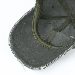 Detail of distressed ripped edges and interior twill sweatband on vintage cotton baseball cap