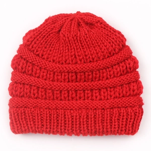 Detailed view of the red chunky knit texture and ribbed edge on a kids beanie