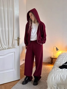 Women's burgundy tracksuit featuring a zip-up hoodie and matching wide-leg sweatpants
