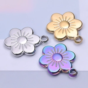Macro shot of 18k gold and rainbow flower charms with integrated loops for DIY jewelry