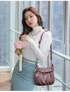 Elegant mauve ruched crossbody bag shown on a model in a bright natural indoor setting