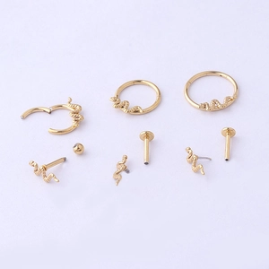 Set of gold snake-shaped ear studs and cuffs in 16G stainless steel on white background