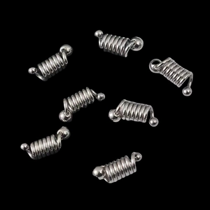 Polished silver stainless steel spring pendants for DIY jewelry making on black background