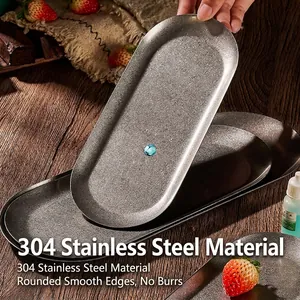 Sleek 304 stainless steel oval serving tray with a matte finish on a dark wood surface