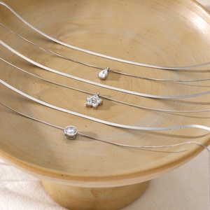 Three silver layered snakeskin necklaces with zircon waterdrop, flower and round pendants