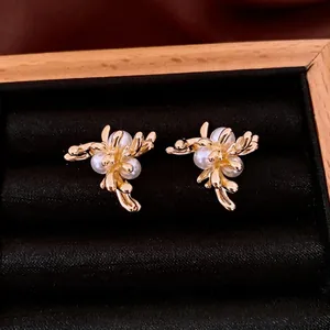 Elegant gold flower pearl earrings in a black velvet jewelry box for women