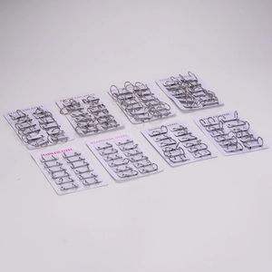 Eight sets of polished stainless steel hoop earrings on cards in a flat lay view
