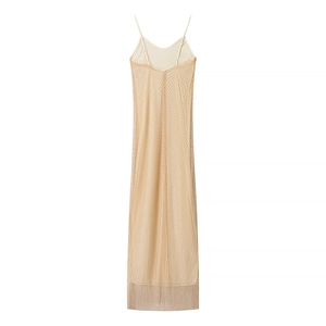 Detail view of champagne sequin mesh long dress showing backless cut and slit