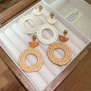 Bohemian rattan hoop earrings in white and natural wood on a velvet jewelry box