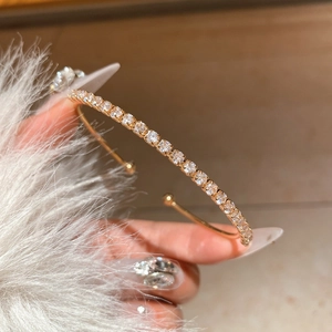 Macro detail of 18K gold plated bangle with sparkling cubic zirconia pavé stones