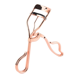 Detailed close-up of rose gold metal eyelash curler with black rubber pad on white background