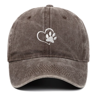 Close-up of heart and dog paw embroidery on a vintage washed brown cotton baseball cap