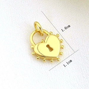 Detail of 1.6x1.1cm golden heart lock pendant with beaded edge and keyhole detail