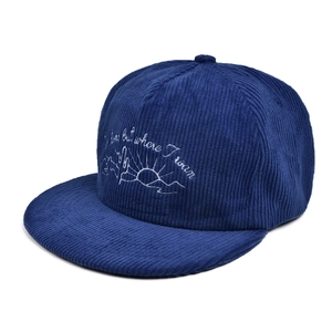 Detail of navy corduroy baseball cap featuring white cactus mountain embroidery and text