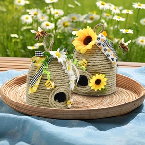 Detail of woven rope beehives decorated with sunflowers and bees for garden decor
