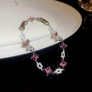 Detail view of Korean style silver bracelet with pink square gemstones and zircons