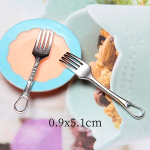 Macro shot of 0.9x5.1cm miniature silver alloy fork for dollhouse kitchen accessories