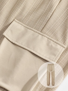 Detail of cargo pocket stitching and textured linen-like fabric on men's jogger pants