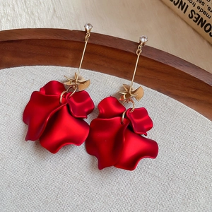 Macro detail of red acrylic petal tassel earrings with silver pins and cubic zirconia