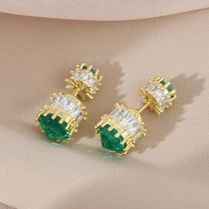 Luxurious gold S925 emerald stud earrings with crystals on soft beige fabric background