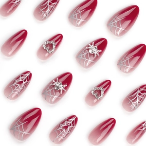 Red gradient almond press-on nails with silver spider webs and 3D heart charms