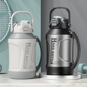316 Stainless steel sport water bottle with carry handle next to tennis racket and dumbbell