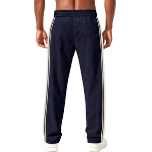 Detail of navy corduroy jogger pants with side stripes and elastic drawstring waist