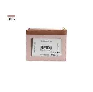 Detailed view of pink RFID blocking wallet with clear ID window and gold zipper