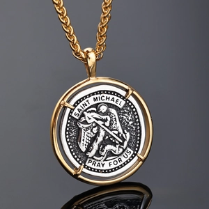 Macro shot of two-tone Saint Michael medallion with silver relief and gold frame