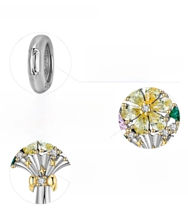Macro detail of S925 sterling silver flower bouquet charm with gold plating and zircons