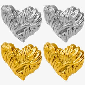 Detail showing gold and silver heart earrings with unique irregular lava textures