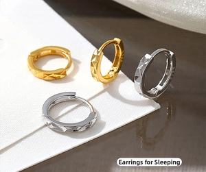 Macro detail of S925 sterling silver hoop earrings with diamond-cut faceted surface
