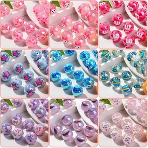 Macro shot of assorted colorful acrylic beads with animal and fruit patterns for DIY