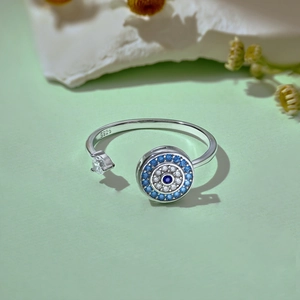 Macro shot of S925 sterling silver evil eye ring featuring vibrant blue zircon stones