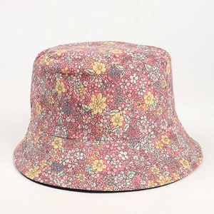 Detail of pink floral bucket hat with small yellow flower pattern on twill cotton