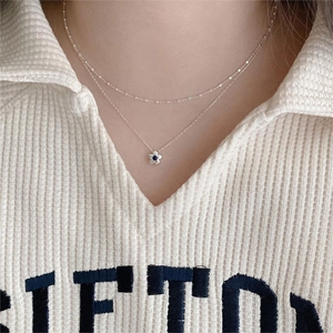 Double-layered 925 sterling silver necklace featuring a blue gemstone flower pendant