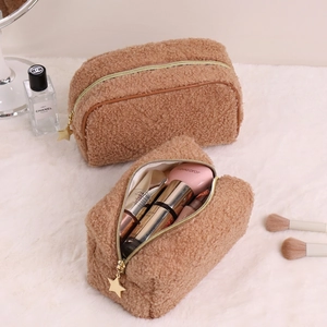 Caramel sherpa makeup bag with quilted texture and star-shaped zipper pull ornament