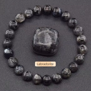 Detailed view of dark grey labradorite crystal beaded bracelet and polished stone