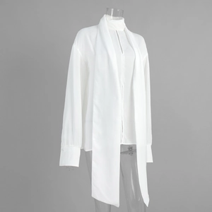 Detail of elegant white chiffon shirt showing long scarf tie neck and flowy fabric