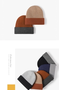 Close-up of color-block knit beanie showing thick ribbed texture and folded cuff detail