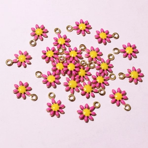 Detailed close-up of yellow and pink enamel sunflower charms for DIY jewelry making