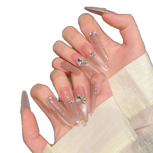 Luxurious handmade almond press-on nails with silver cat-eye effect and sparkling rhinestones