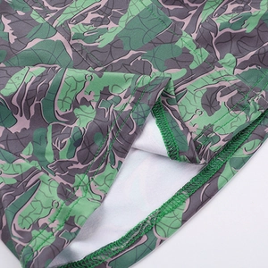Close-up of tight stitching and green purple camouflage pattern on the floral tube top