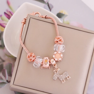 Detailed macro view of rose gold reindeer charm and multifaceted glass beads on a snake chain