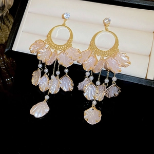Elegant gold drop earrings with pink shell petals and white pearls in a jewelry box